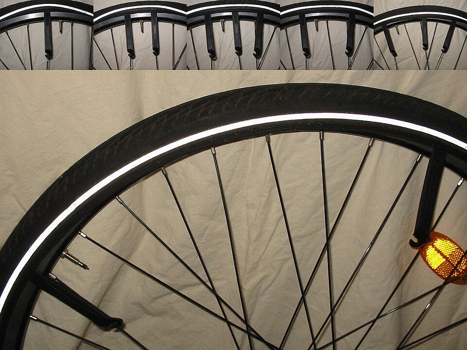 Plastic tire levers hooked under a bike tire to lift it off the rim