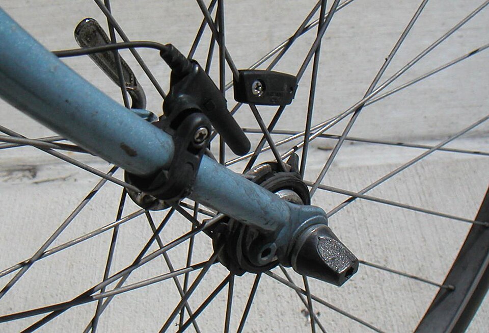 A wheel speed sensor clamped to a bike fork, with a small magnet fixed to a spoke